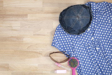 Outfit of clothes and woman accessories on wooden background,essential vacation items for travel and summer travel background.