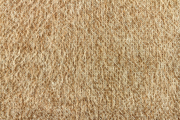 beige melange knitted textured background with a pattern closeup