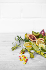a variety of fruits and measuring tape