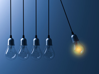 One hanging light bulb glowing different and stand out from unlit incandescent bulbs like newtons cradle on dark blue background, leadership and different business creative idea concept. 3D rendering.