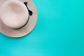 Fototapeta na wymiar Summer panama straw hat on green pastel background.