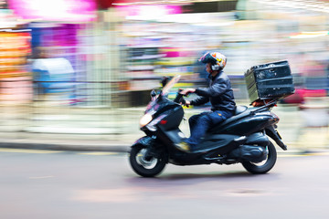 scooter messenger on the road in motion blur © Christian Müller
