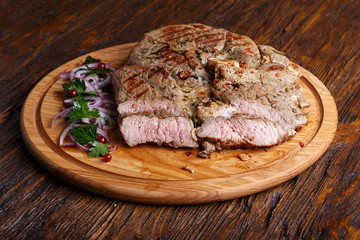 Medium steak on a wooden board