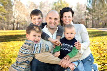 Happy family, father, mother and four sons photo in nature