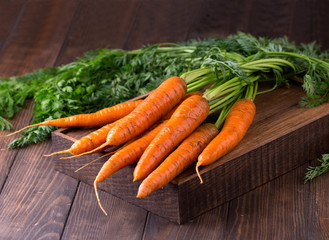 fresh carrots bunch on rustic wooden background