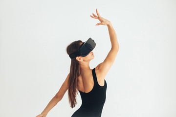 Sport athlete girl with a beautiful figure dancing with glasses of virtual reality. Future...