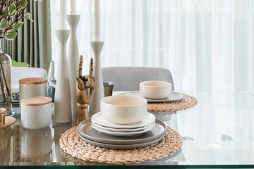 glass dining table with table set in modern dining room
