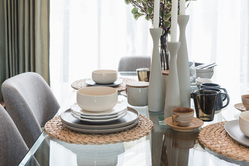 glass dining table with table set in modern dining room