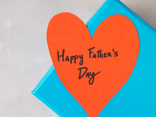 Blue box present with paper red heart hand written Happy Father's day