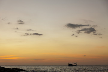 Dramatic seascape of rock and boat in the sea andaman ocean. Colorful sunset in phuket thailand.