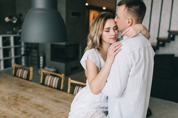 Fototapeta premium Young couple flirting on the table in home.