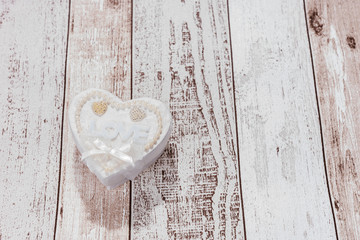 One heart with the word Love on wooden background