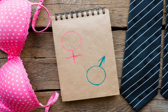 male and female accessories and gender symbols in a notebook