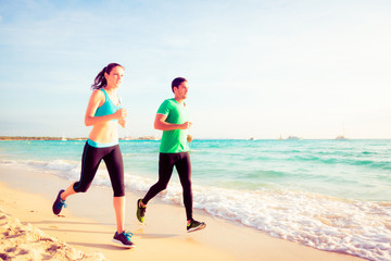 Young Couple Jogging On The Beach