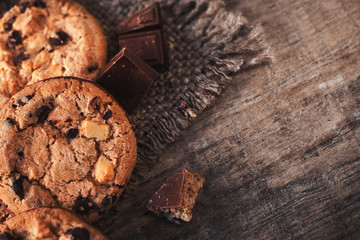 Chocolate chip cookies on dark old wooden table with place for text.,  freshly baked. Selective Focus with Copy space.