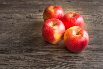 Juicy apples on a brown board with place for a text.