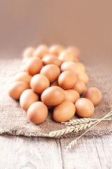 Eggs on wooden background closeup..