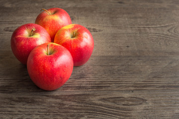 Juicy apples on a brown board with place for a text.
