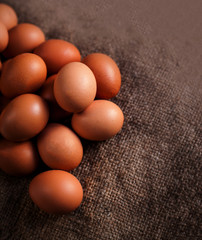 Eggs on wooden background closeup..