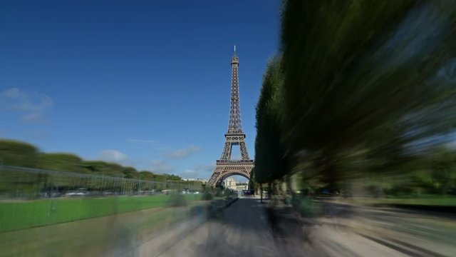 Hyperlapse of the Eiffel tower with clouds on a sunny day.