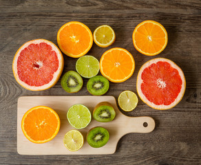 Slices fresh fruits on cutting board and  table