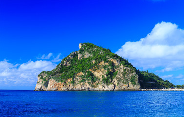 Fototapeta na wymiar a small island in the calm sea in warm summer day
