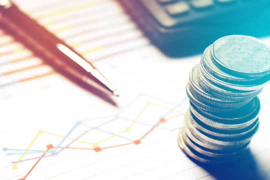Summary report and financial analyzing concept, Pen and calculator with thailand coin on paperwork.