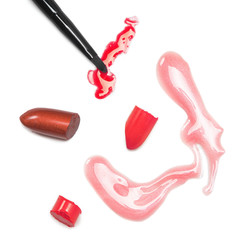 Lipstick and lip gloss with makeup brush on white background