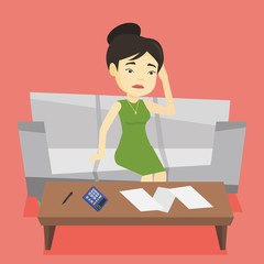 Unhappy asian woman accounting home bills.