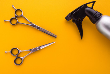 hairdresser tools on yellow background top view, barber scissors