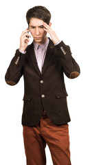 Fototapeta premium Portrait of a young pensive businessman talking on cell phone