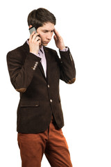 Portrait of a young pensive businessman talking on cell phone