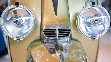 Large headlights of a restored scooter