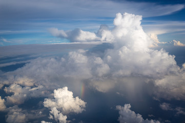 View from airplane the blue sky and rainbow while raining