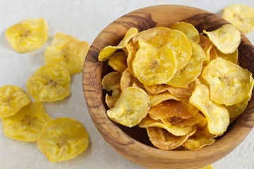 Fried plantain chips in a wooden bowl. © Frantisek Keclik