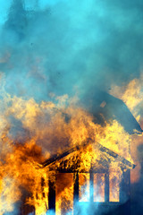 Close up of burning house. Vertical image.
