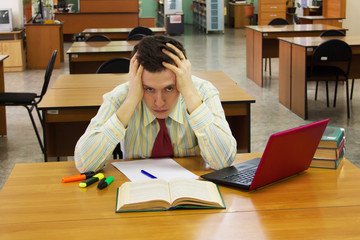 Young student man feel stressed and holding his head.
