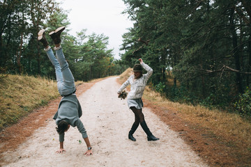Beautiful youth couple flirting and joking in outdoor.