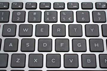 Modern laptop QWERTY keyboard closeup