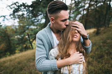 Beautiful youth couple flirting and joking in outdoor.