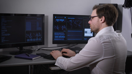 The room with computers. The man using the special software tries to find important information....