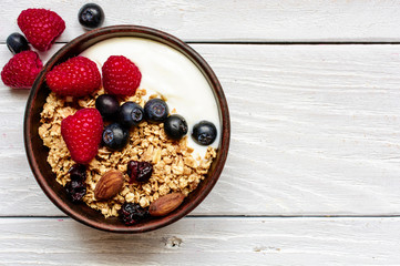 homemade greek yogurt with granola and fresh berries in a bowl