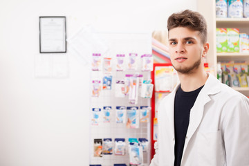 Pharmacist man at work looking in camera