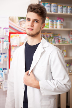 Pharmacist man in front of his desk at work
