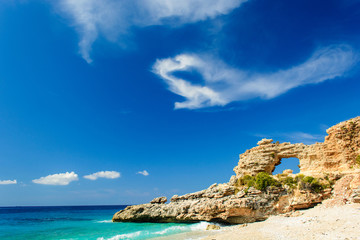 Fototapeta na wymiar ionian sea coast landscape with sandy beach and rock