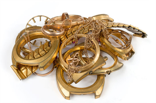 Scrap of gold. Old and broken jewelry, watches on a white background.