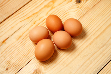 Eggs lay on wooden background. Food ingredient.
