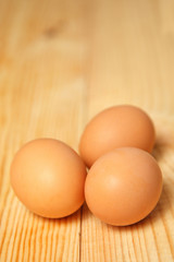 White eggs on burlap over wooden background