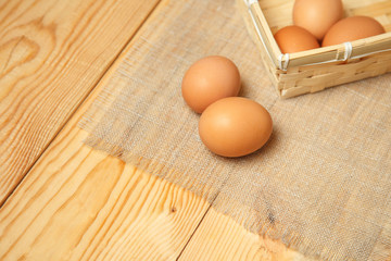 Fresh farm eggs on a wooden rustic background