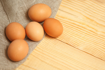 fresh farm eggs on sackcloth rustic background.